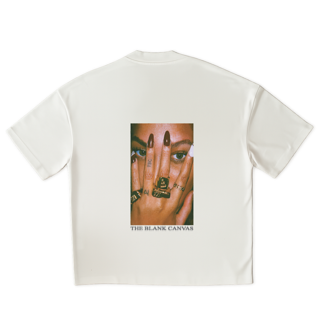 White t-shirt with a graphic of a face and hands on the back, featuring 'The Blank Canvas' brand.